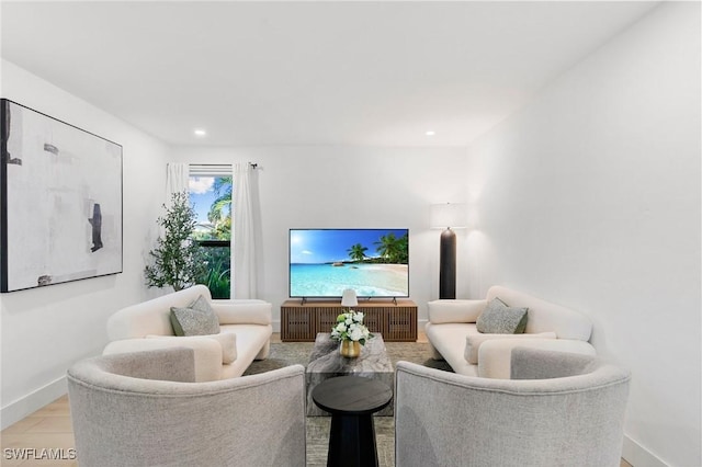 living area with baseboards and recessed lighting