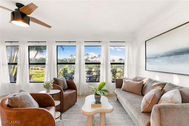 sunroom / solarium with a ceiling fan