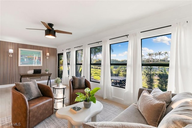 sunroom featuring plenty of natural light and a ceiling fan