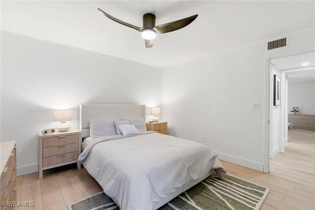 bedroom featuring light wood-style floors, visible vents, baseboards, and a ceiling fan