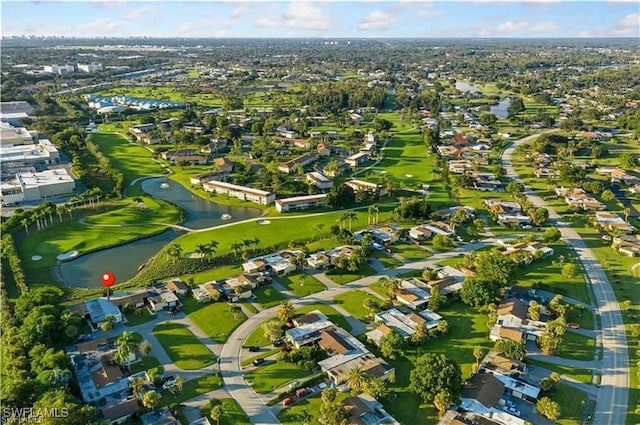 drone / aerial view with a residential view, a water view, and golf course view