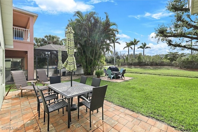 view of patio with glass enclosure and outdoor dining area