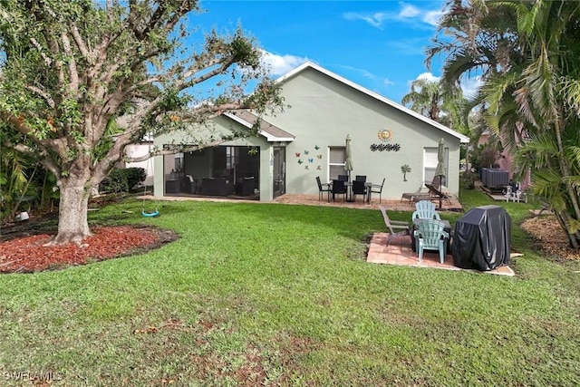 back of house with stucco siding, a patio area, a lawn, and central AC unit