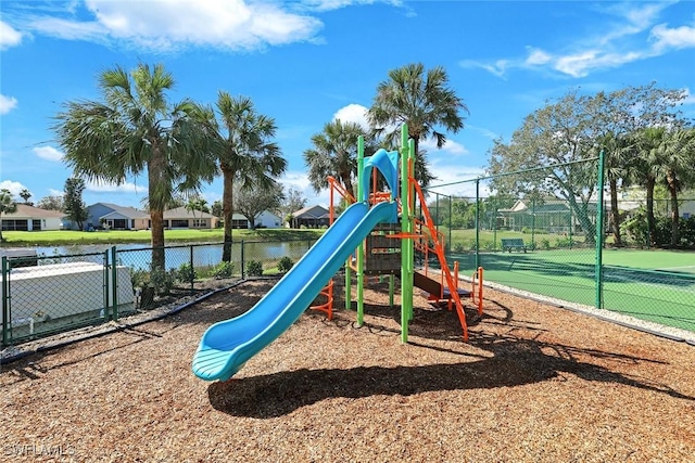 community play area with a water view and fence