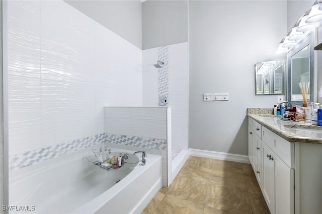 bathroom featuring a garden tub, a sink, baseboards, a tile shower, and double vanity