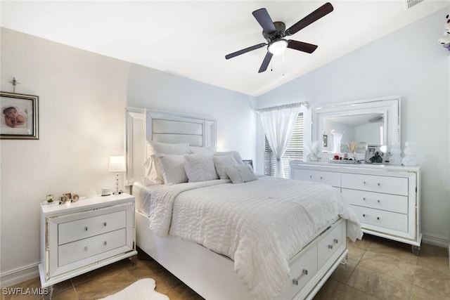 bedroom featuring lofted ceiling, ceiling fan, visible vents, and baseboards