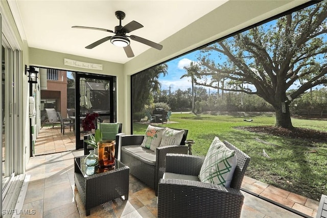 view of patio / terrace featuring outdoor lounge area, a lanai, and a ceiling fan