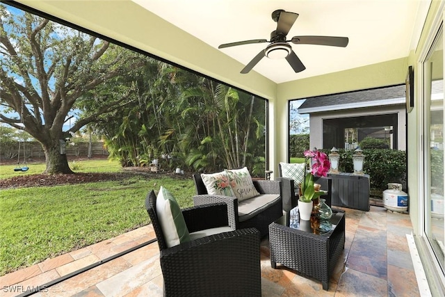 sunroom featuring a ceiling fan