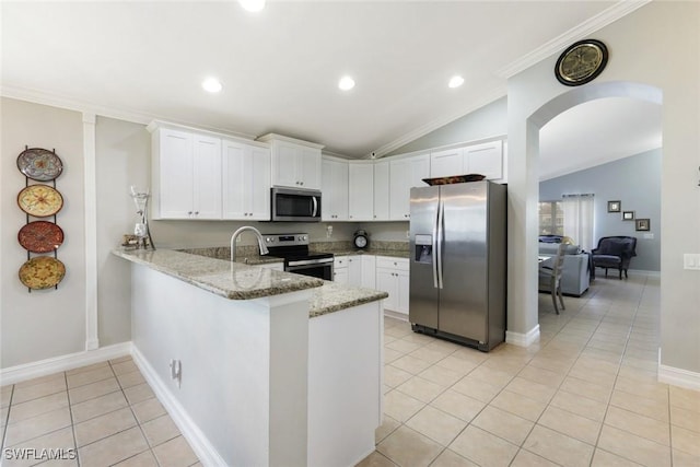 kitchen with light stone counters, arched walkways, stainless steel appliances, light tile patterned flooring, and a peninsula