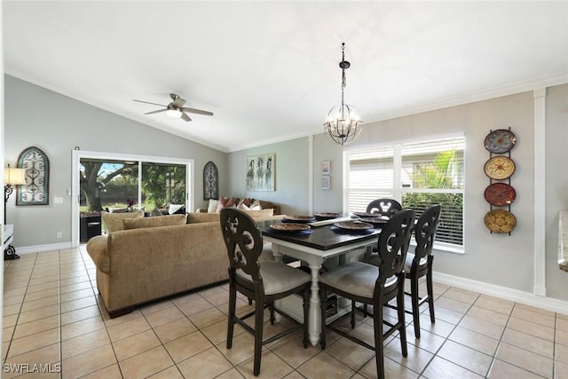 dining area featuring crown molding, light tile patterned flooring, vaulted ceiling, baseboards, and ceiling fan with notable chandelier