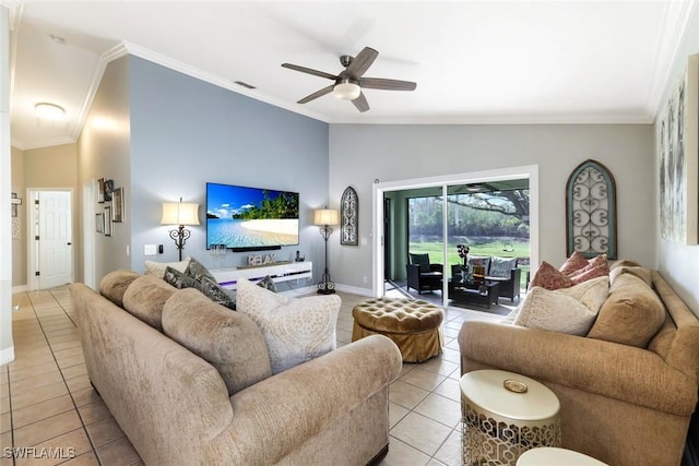 living room featuring lofted ceiling, light tile patterned floors, baseboards, and crown molding