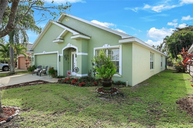 ranch-style home featuring a front lawn, concrete driveway, an attached garage, and stucco siding