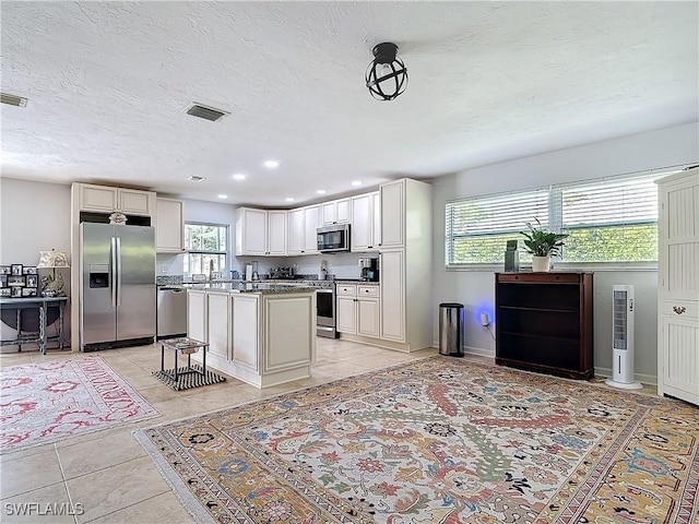 4364 Beechwood Lake Dr, Naples, FL 34112 - kitchen featuring a healthy amount of sunlight, light tile patterned floors, visible vents, and stainless steel appliances