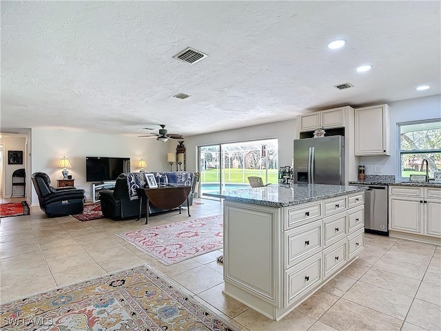 4364 Beechwood Lake Dr, Naples, FL 34112 - kitchen featuring appliances with stainless steel finishes, a sink, visible vents, and light stone countertops