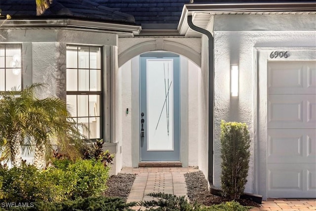 doorway to property with stucco siding