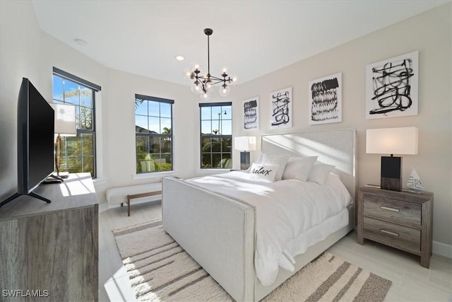 bedroom with baseboards and a chandelier