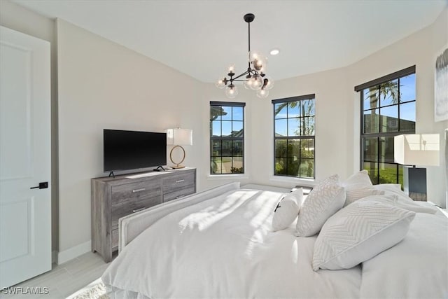 bedroom with a notable chandelier and baseboards