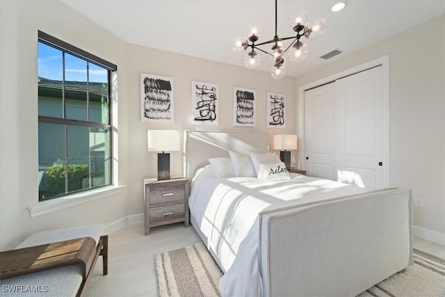 bedroom with visible vents, baseboards, a closet, and an inviting chandelier