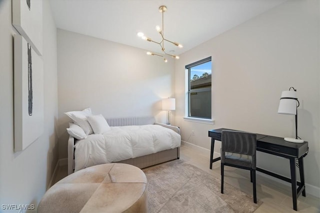 bedroom with baseboards and a chandelier