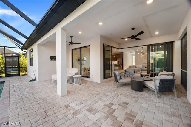 view of patio / terrace with a lanai, a ceiling fan, and an outdoor hangout area