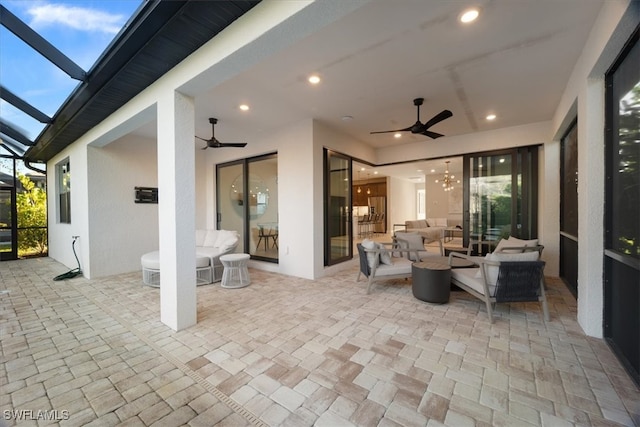 view of patio with a lanai, an outdoor living space, and a ceiling fan