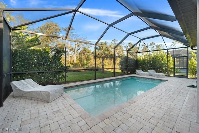 outdoor pool with a patio and a lanai