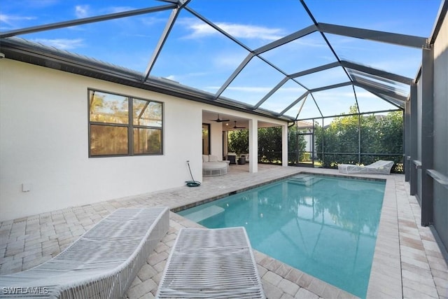 outdoor pool with a patio, a lanai, and a ceiling fan