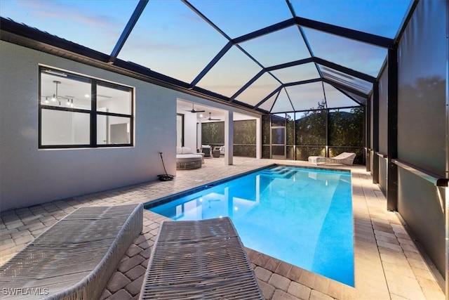 outdoor pool featuring a patio, a lanai, and a ceiling fan