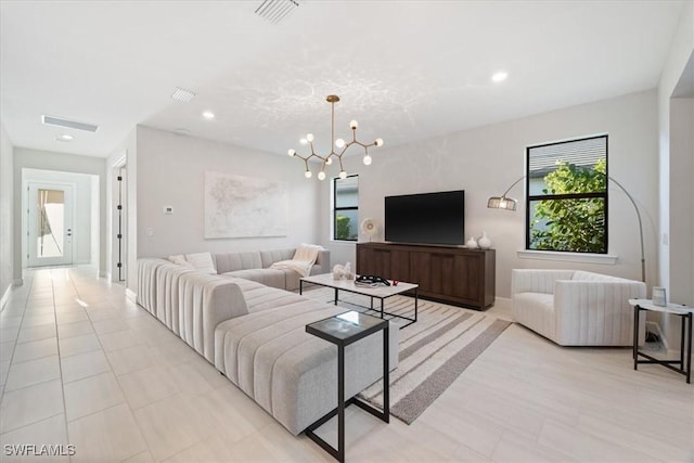 living room featuring light tile patterned floors, visible vents, baseboards, recessed lighting, and a notable chandelier