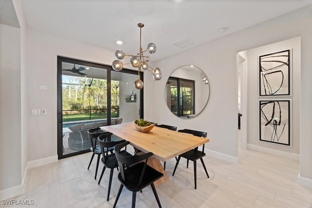 dining space with an inviting chandelier and baseboards