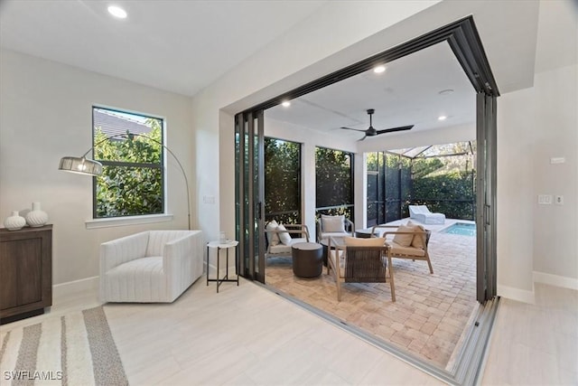 entryway with recessed lighting, baseboards, a ceiling fan, and a sunroom