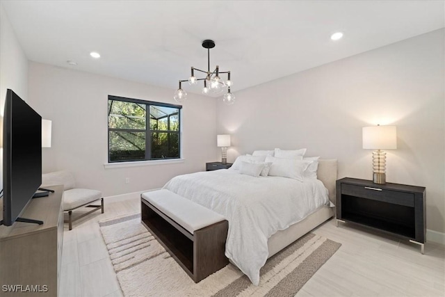 bedroom with recessed lighting, an inviting chandelier, and baseboards