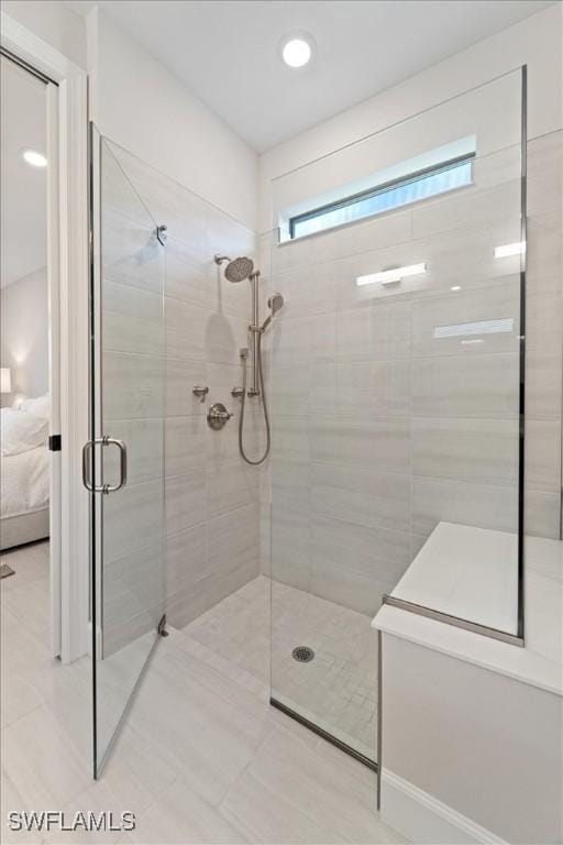 bathroom featuring a shower stall and ensuite bathroom