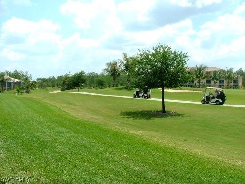 view of property's community with a lawn