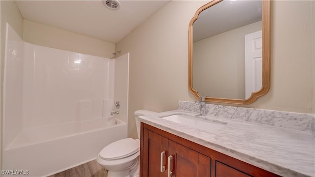 full bathroom with toilet, wood finished floors, vanity, visible vents, and tub / shower combination