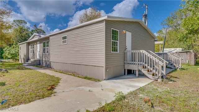 view of property exterior with a yard