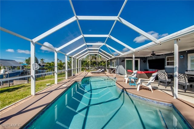 pool with a lanai, a ceiling fan, and a patio