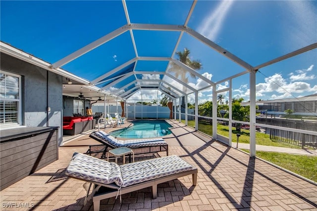 exterior space with ceiling fan, a fenced backyard, a lanai, a fenced in pool, and a patio area