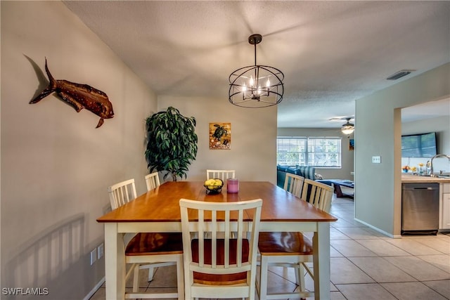 dining space featuring light tile patterned floors, baseboards, visible vents, and ceiling fan with notable chandelier