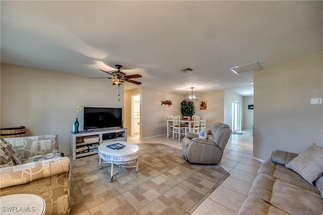 living area featuring visible vents, ceiling fan, baseboards, and light tile patterned floors