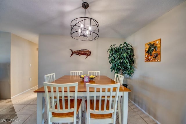 dining room featuring baseboards, light tile patterned flooring, and a notable chandelier