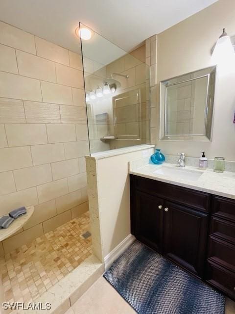 full bathroom with tile patterned flooring, walk in shower, and vanity