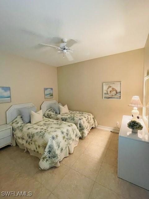 bedroom featuring ceiling fan, baseboards, and light tile patterned flooring