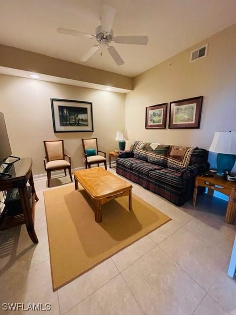 living room featuring visible vents, ceiling fan, and light tile patterned flooring