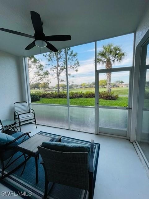 sunroom featuring a ceiling fan