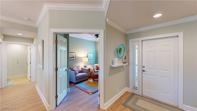 entryway featuring crown molding, recessed lighting, a ceiling fan, light wood-type flooring, and baseboards