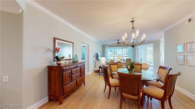 dining space featuring light wood-type flooring, visible vents, and crown molding