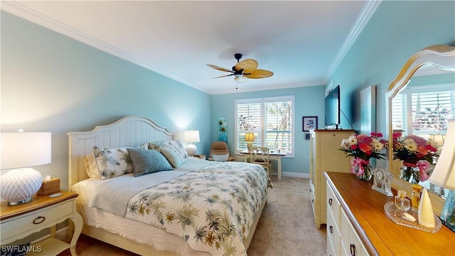 bedroom featuring light colored carpet, crown molding, baseboards, and ceiling fan