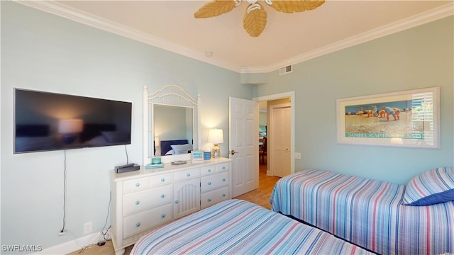 bedroom with ceiling fan, visible vents, and crown molding