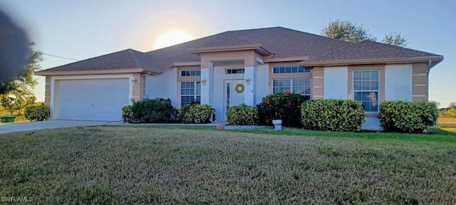 ranch-style house featuring a garage, a front lawn, and stucco siding